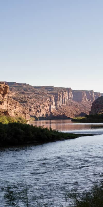The Colorado River runs through the red cliffs in Moab.