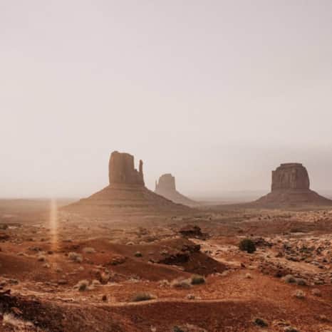 Vibrant red rock against stormy skies.