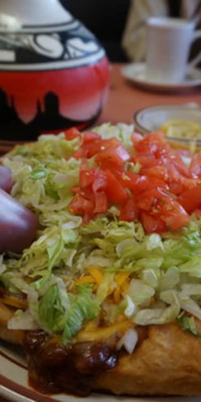 A decorated plate of fry bread.
