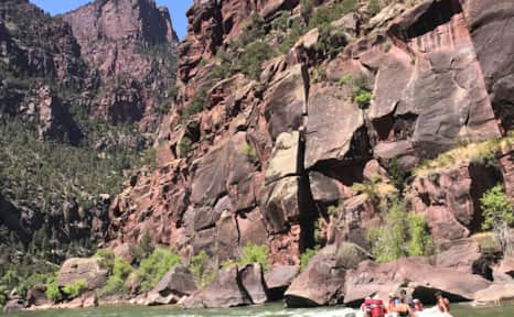 Cliff walls abruptly rise up from the water.