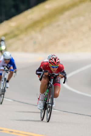 A group of cyclists racing on the road.