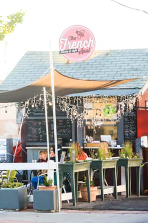 People dining on the patio in front of a restaurant.