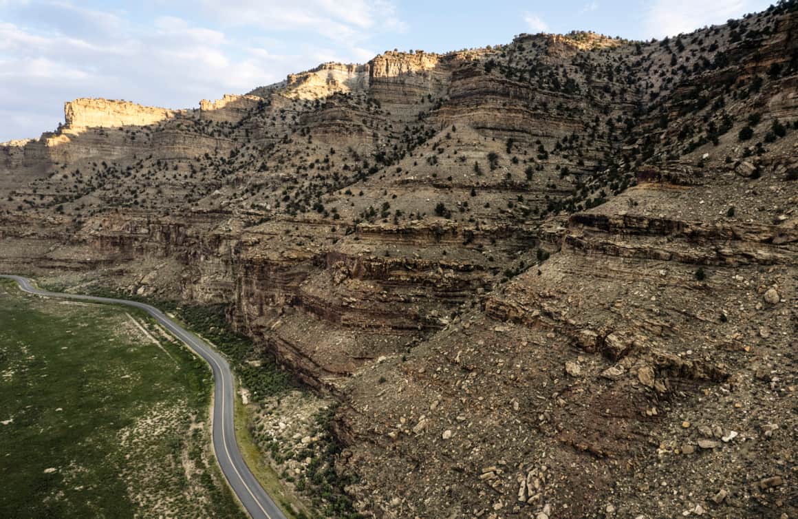 The way to Nine Mile Canyon is a long desert stretch that shifts from paved road to a dusty, winding descent.