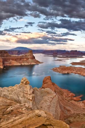 Aerial view of a reservoir surrounded by red rock formations.