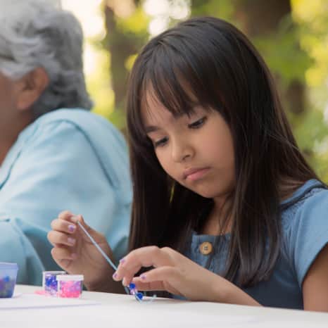 It’s tradition that the children gather around while a tribal elder shares truths and other important information with them.