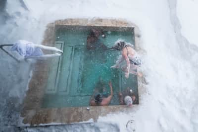 At Alta, discover heated tubs among the snowy landscape after a day filled with skiing.