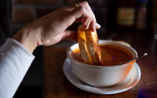 Boneyard Saloon's serves up comforting and hearty options, including rosemary grilled cheese with tomato basil soup, colossal wings and wood-fired artisan pizzas.