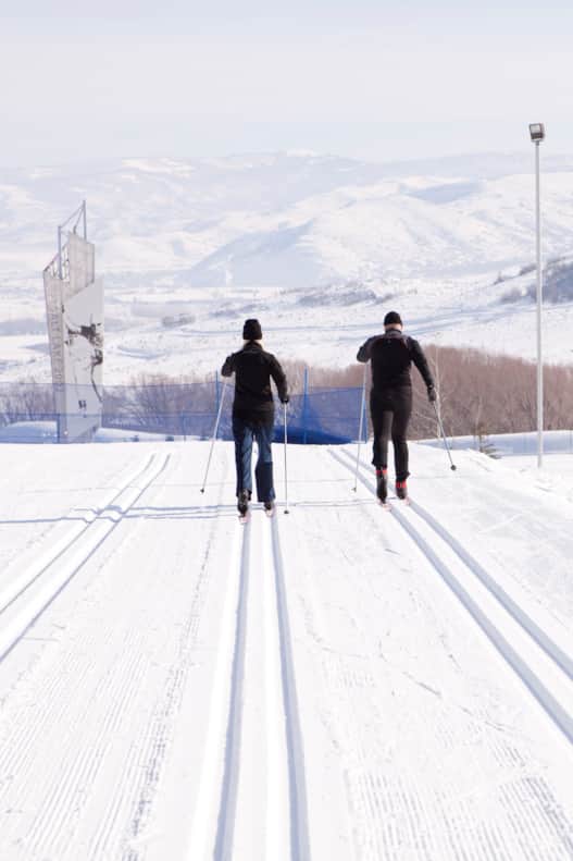 It’s best to wear a thin base layer, a light shell and sunglasses — cross-country skiing is like jogging in the snow.