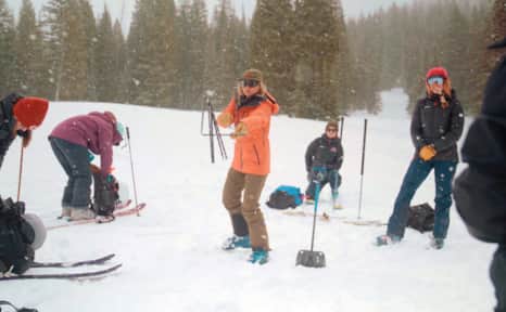 Before heading to the backcountry, make sure you know how to use your safety gear. Pictured here, a skier practices deploying their avalanche probe.